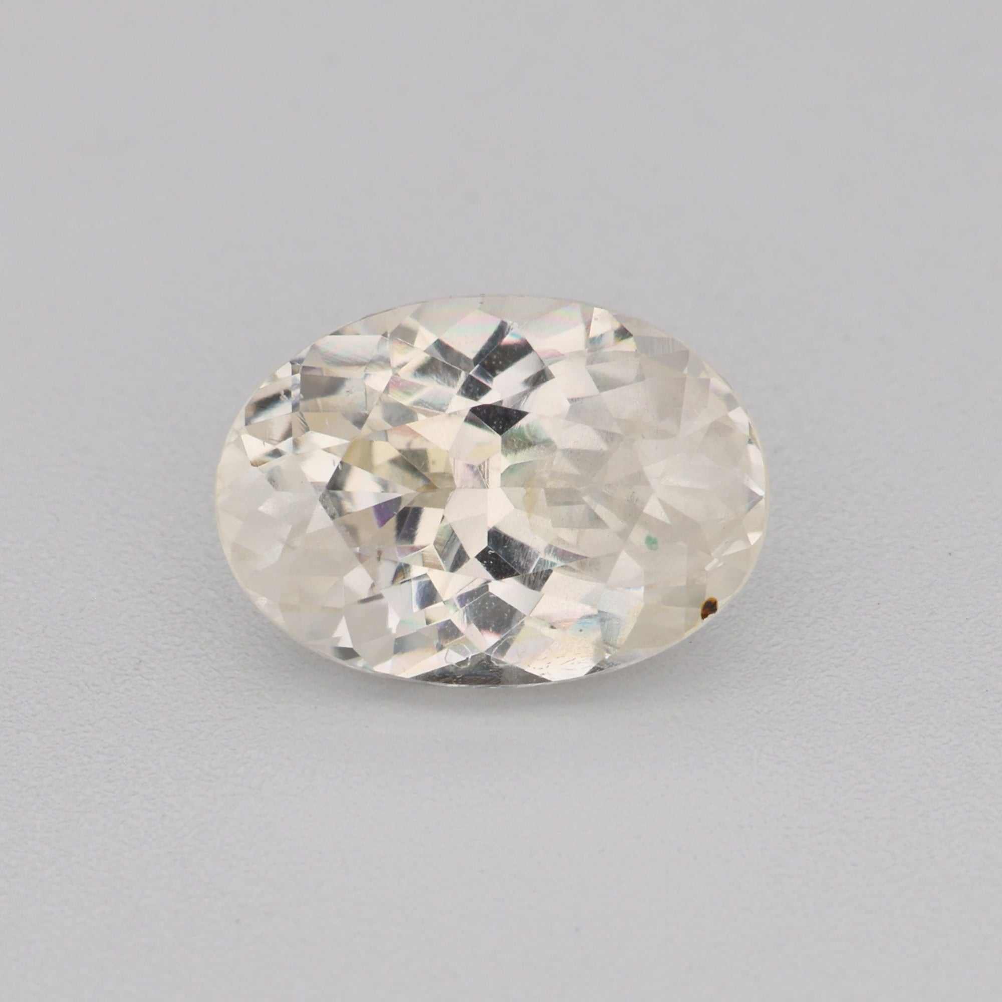 0.95ct 7x5mm oval white sapphire gemstone with high clarity and brilliance, perfect for elegant jewelry designs