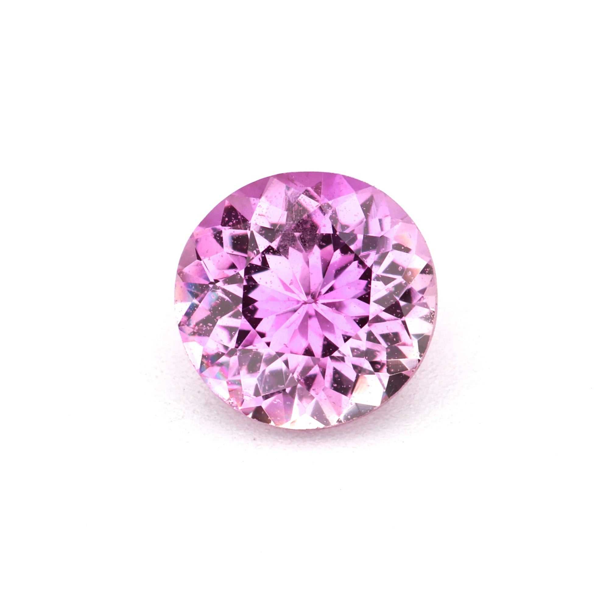 Close-up of a natural 0.62 ct pink sapphire gemstone with vibrant color and excellent clarity
