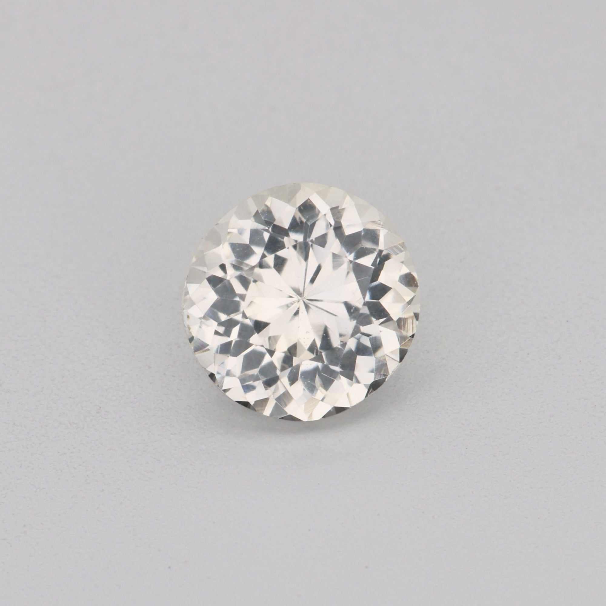 0.68ct 5mm round white sapphire gemstone with brilliant sparkle and precision cut