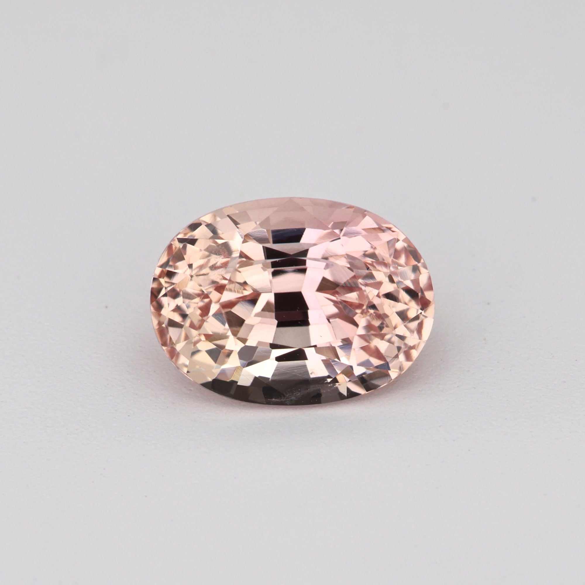 1.23 ct peach sapphire gemstone with warm peach hues and excellent clarity, ideal for custom jewelry.