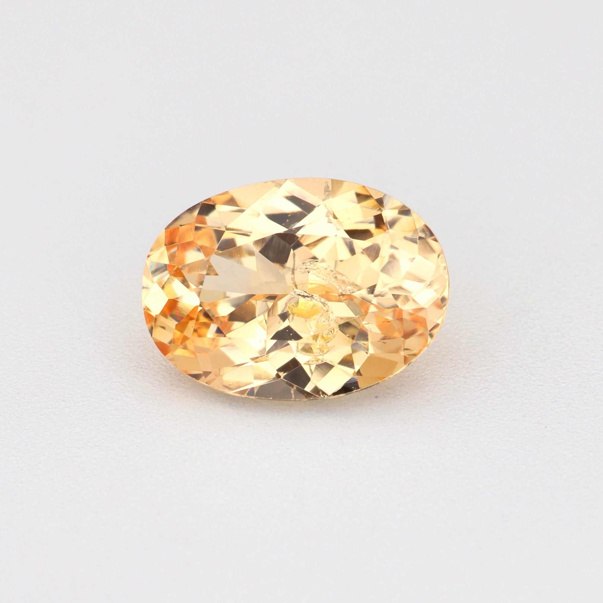 0.81 carat natural unheated peach sapphire gemstone with warm peachy-orange hue and excellent clarity