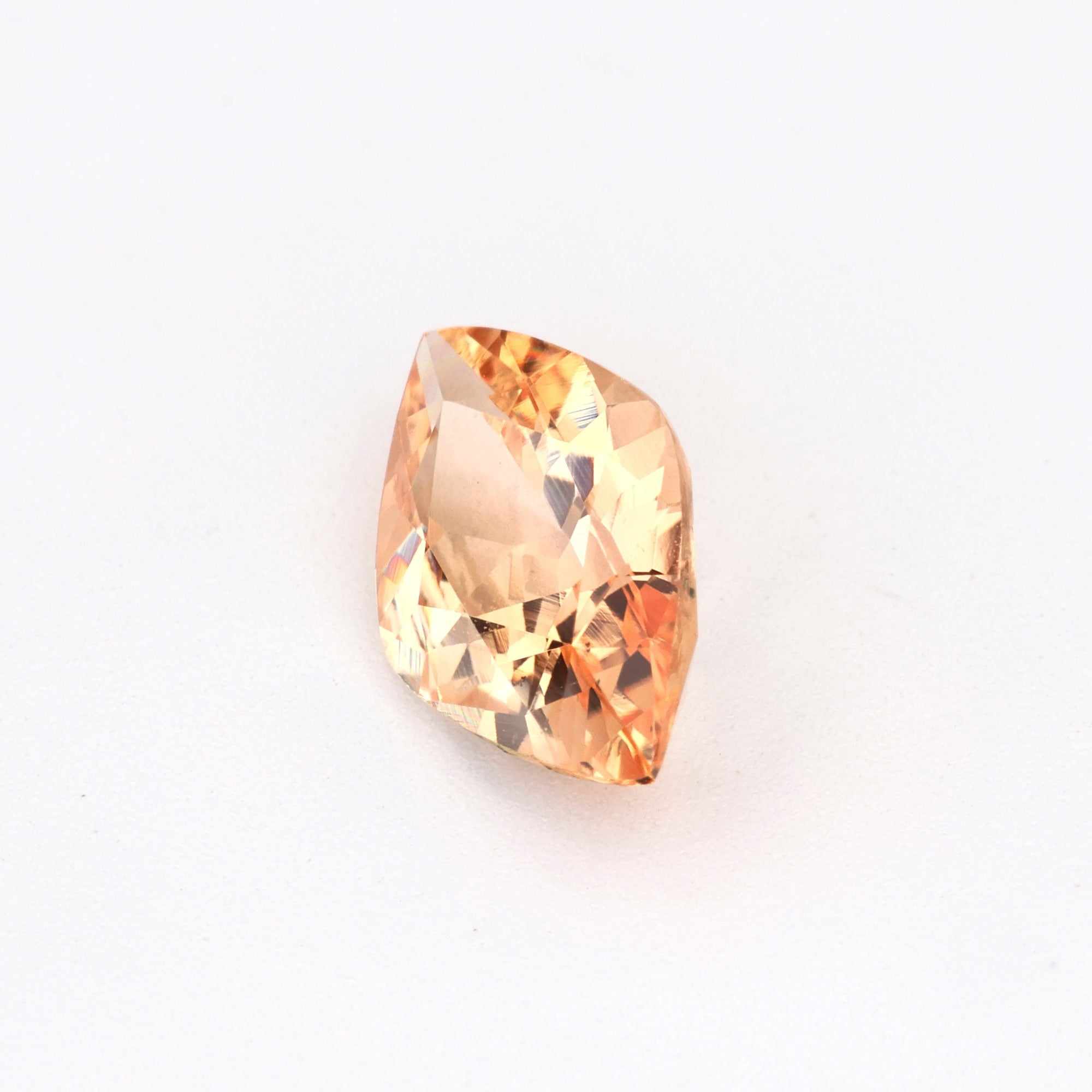 0.79 ct unheated peach sapphire gemstone with excellent clarity and soft peach hue for jewelry designs