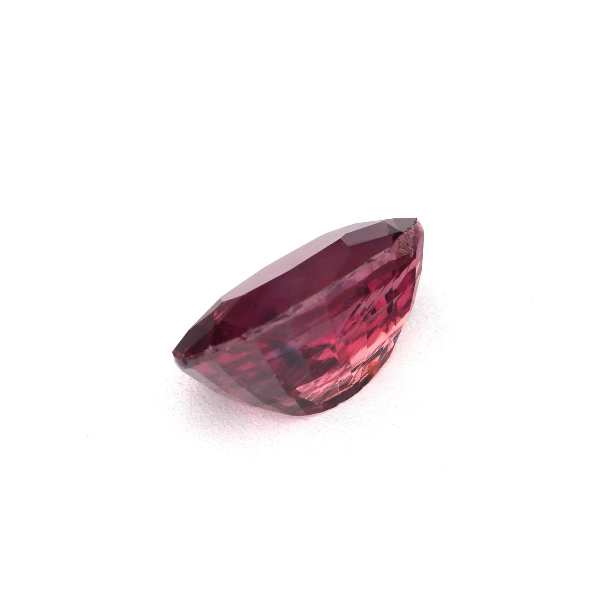 Close-up of a 1.17 ct transparent ruby gem with deep red and orange hues, expertly cut for maximum brilliance and clarity