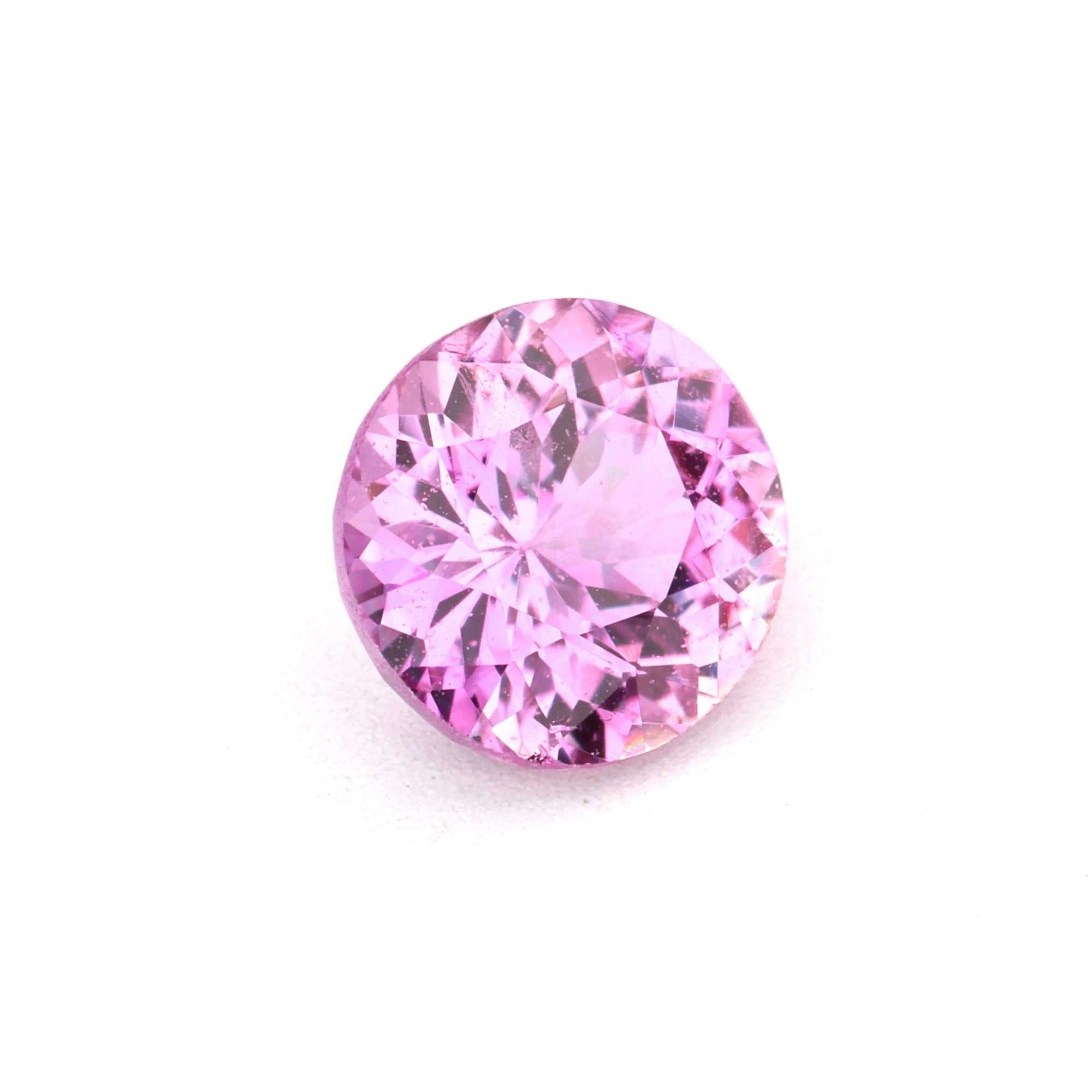 Close-up of a brilliant 0.62 ct natural pink sapphire gemstone with excellent clarity and vibrant color