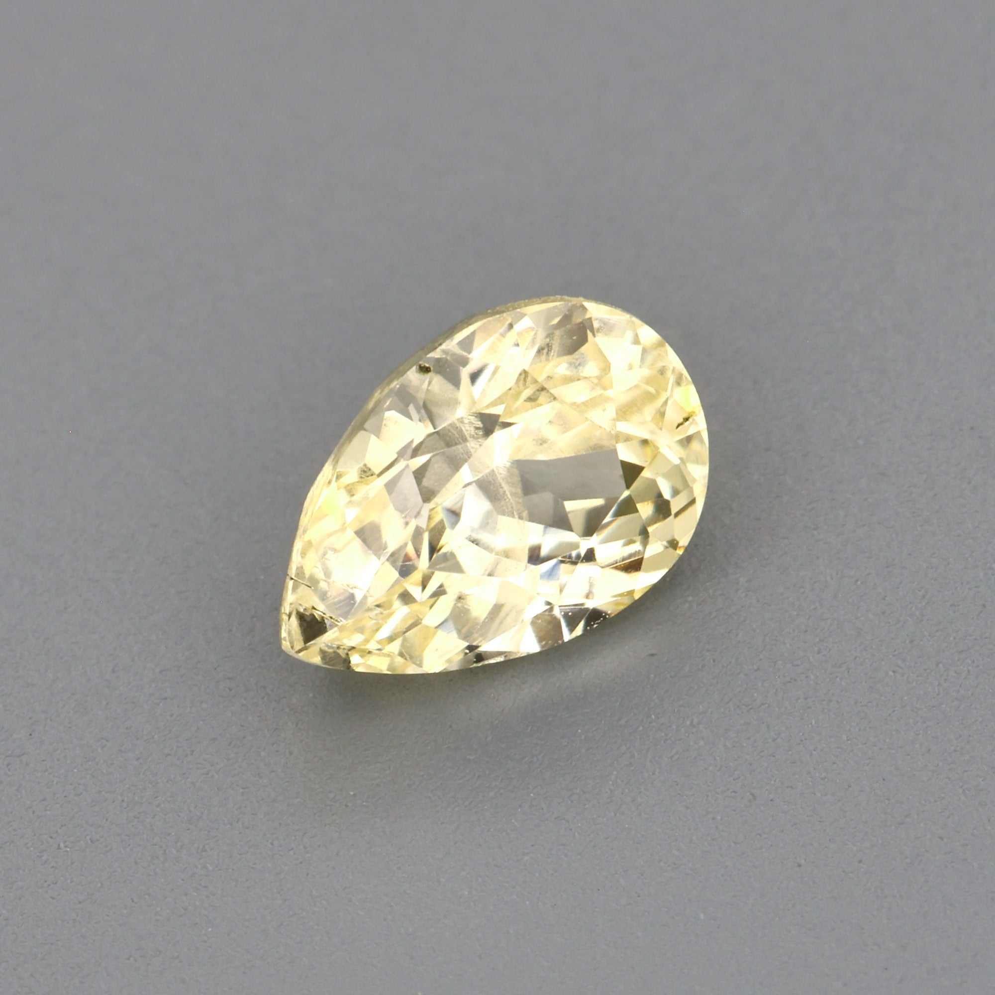 0.61 ct light yellow sapphire pear cut natural untreated gemstone with excellent clarity and golden hue