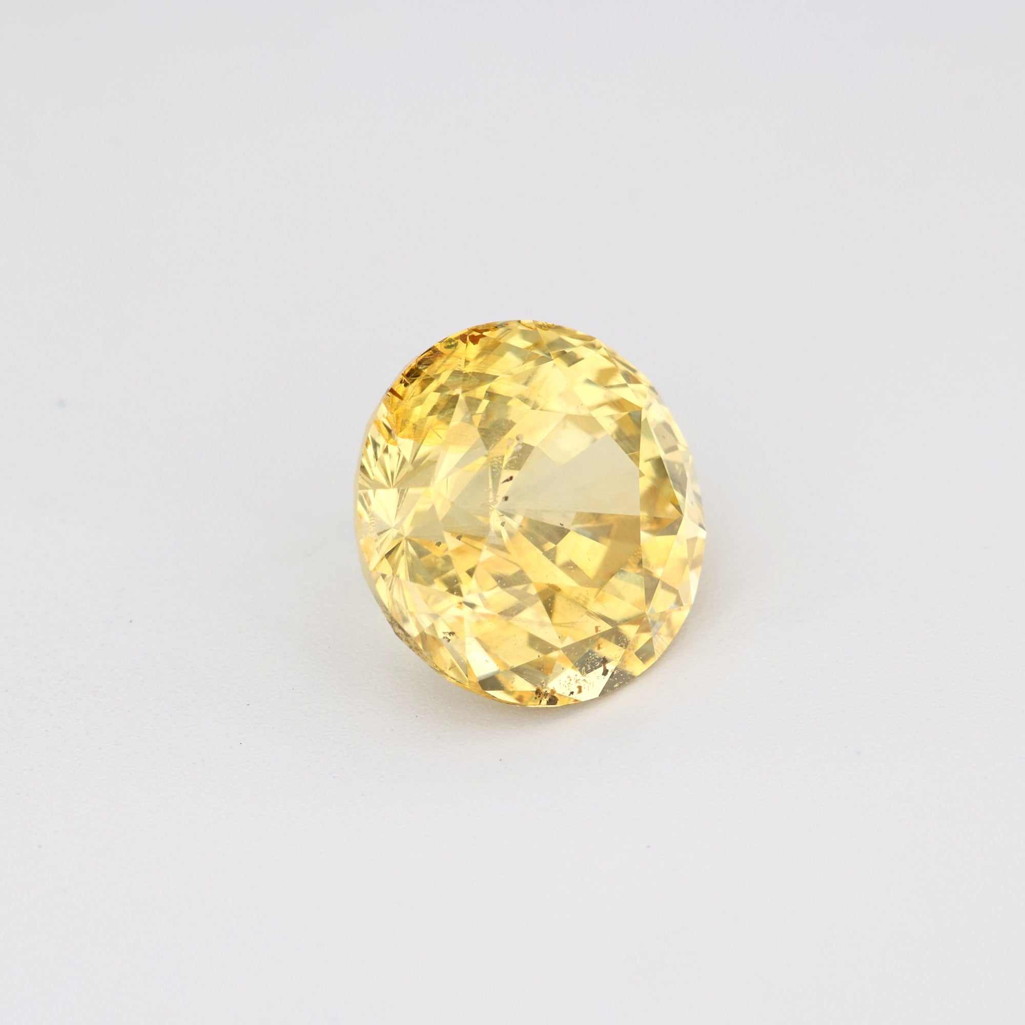 3.13 ct unheated natural yellow sapphire round brilliant cut gemstone with excellent clarity and warm golden hue