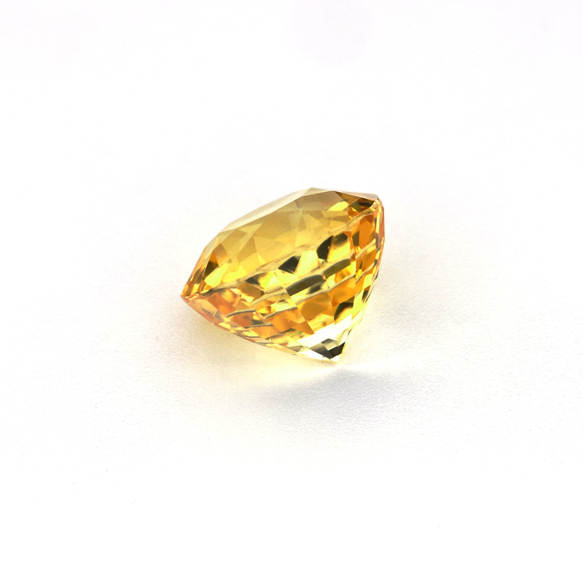 1.50 ct vivid Round Yellow Sapphire on display showing golden hue from multiple angles