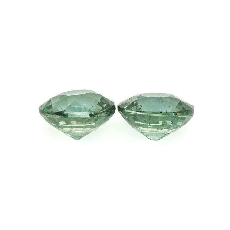 Matched pair of 1.50 ctw natural untreated teal sapphire gemstones with brilliant cut and rich teal color for custom jewelry designs