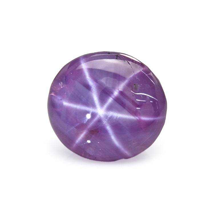 Close-up of a glowing star sapphire gemstone showcasing its six-rayed asterism effect and deep blue color from Crescent Gems collection