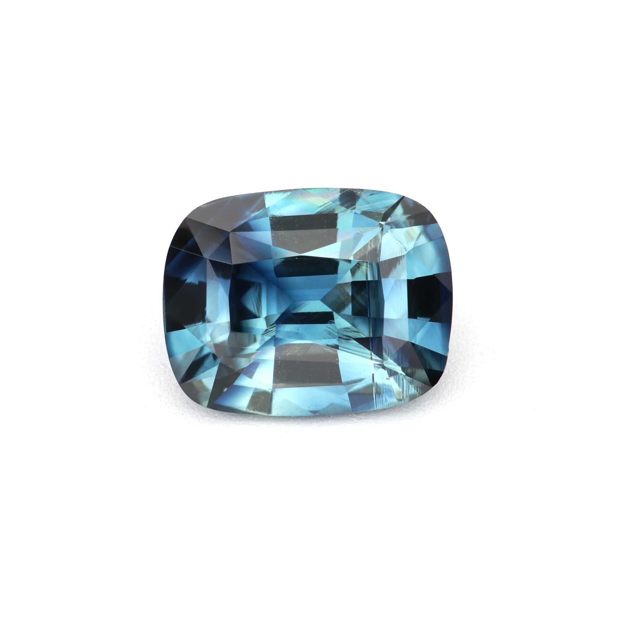 1.30 ct cushion unheated teal sapphire showing blue-green color and brilliance