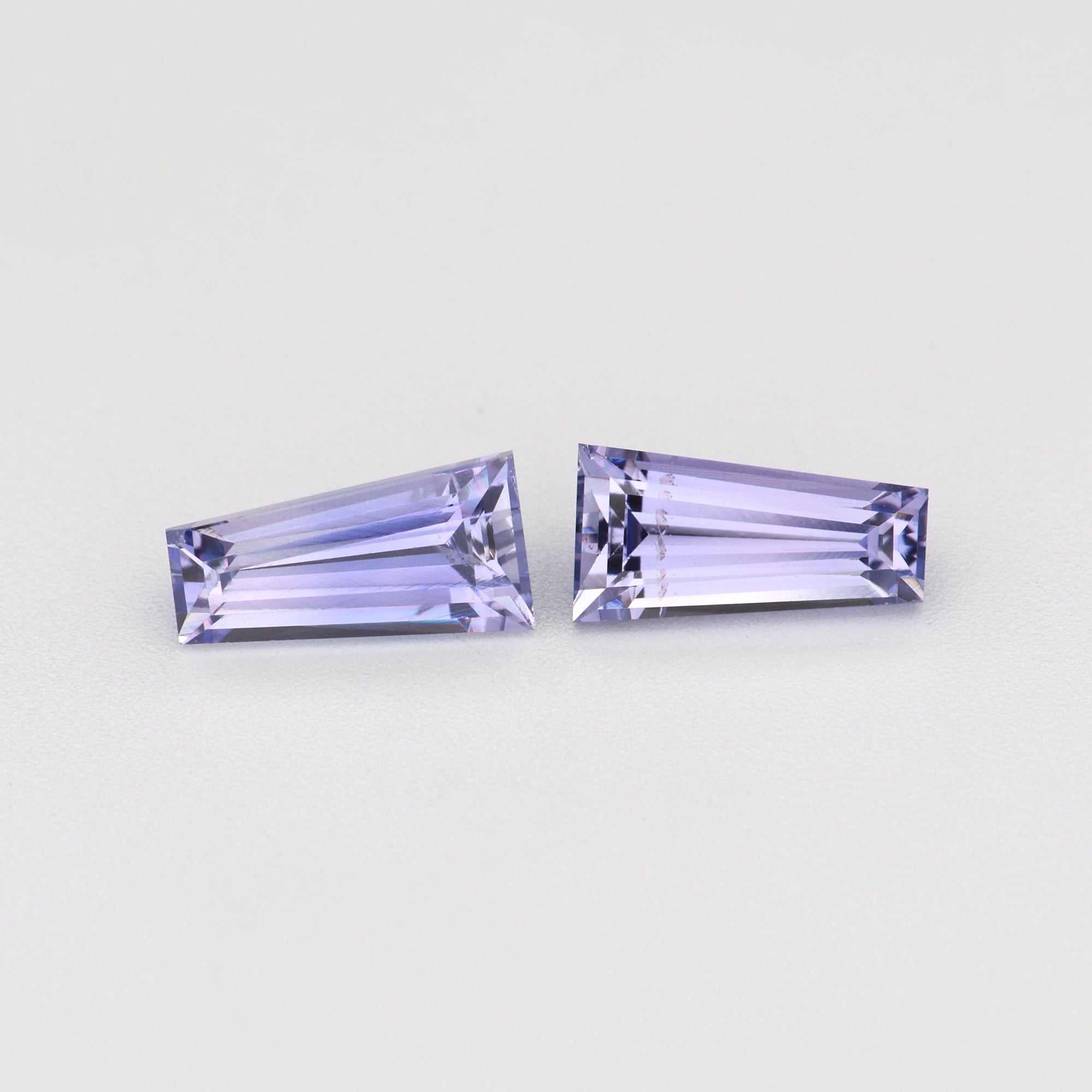 Matched pair of 0.79 ctw tapered baguette cut natural purple sapphires in four-prong settings
