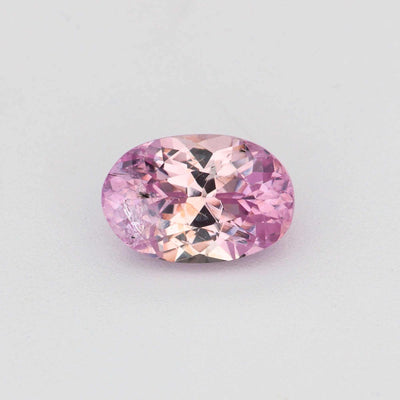 Close-up of 0.57 ct natural unheated pink sapphire gemstone with soft pink hue and excellent clarity