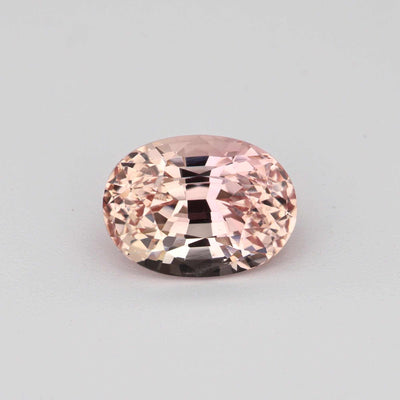 1.23 ct peach sapphire gemstone with warm peach hues and excellent clarity, ideal for custom jewelry.