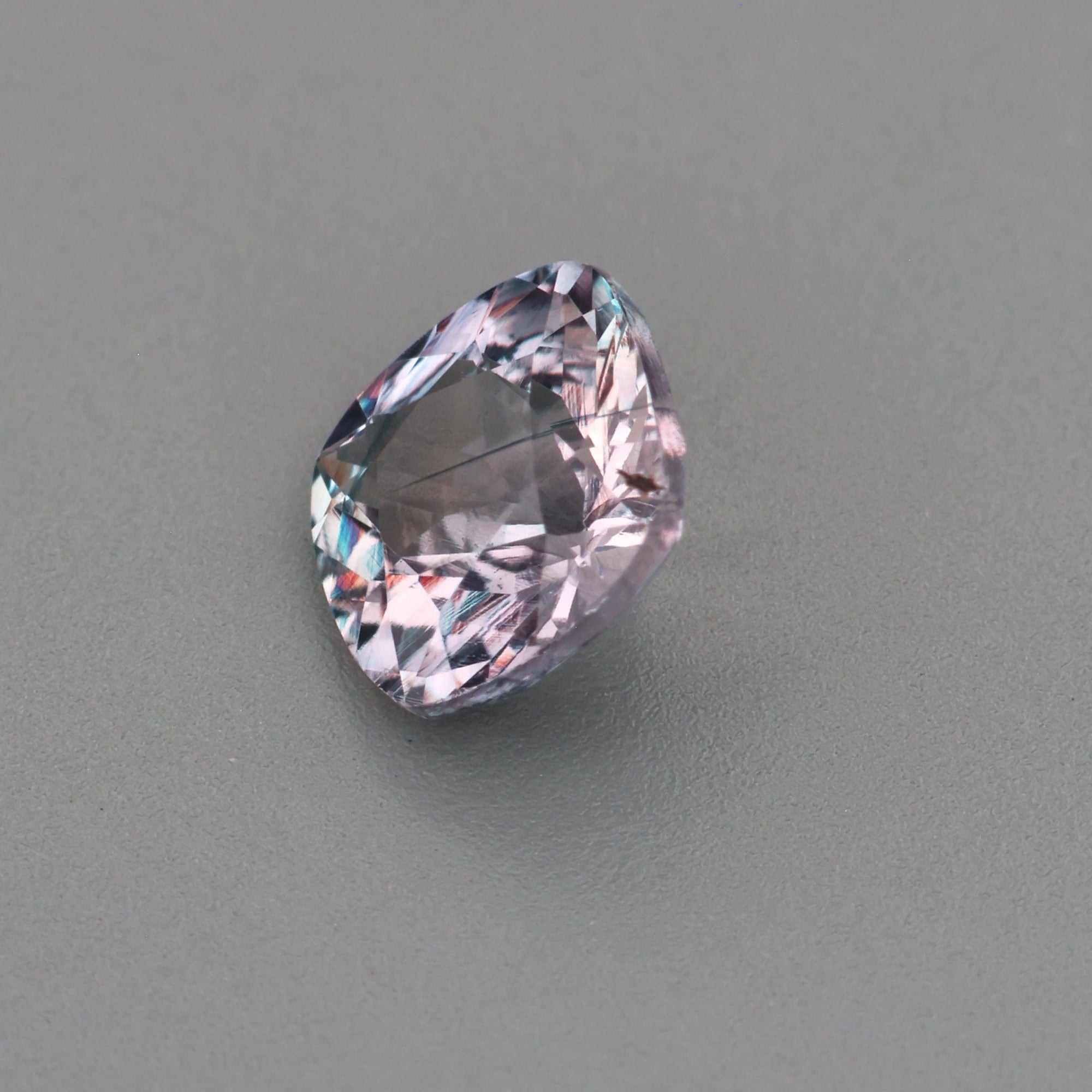 0.63 ct natural unheated violet sapphire with violetish gray color and precision cut sparkle