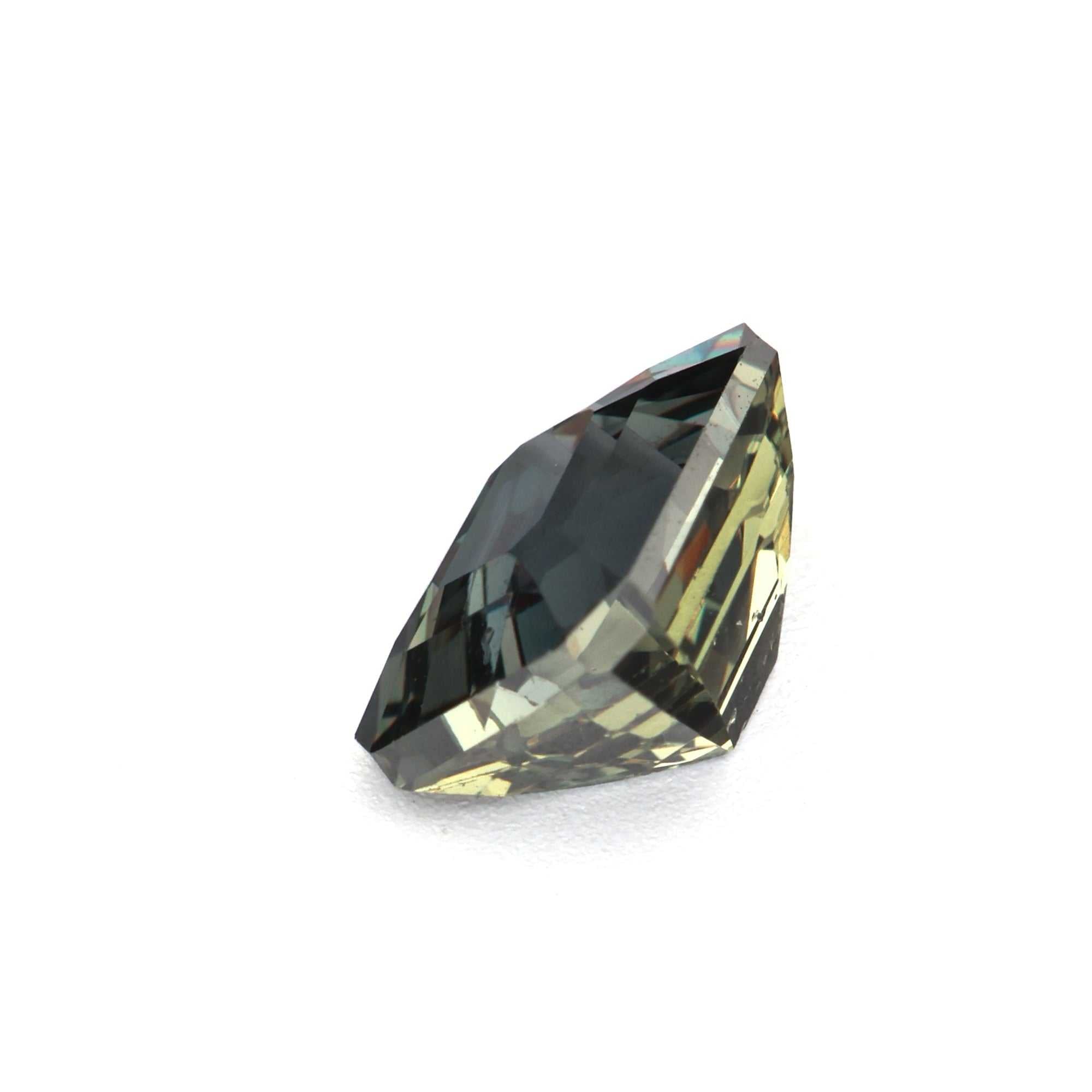 Close-up of a 1.03ct untreated natural color change sapphire shifting from green to reddish purple under different lighting