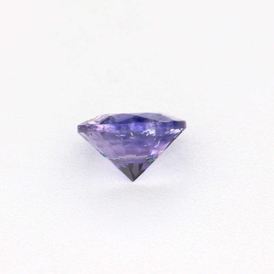 Close-up of a 0.44 ct untreated violet sapphire gemstone with rich purple color and excellent clarity