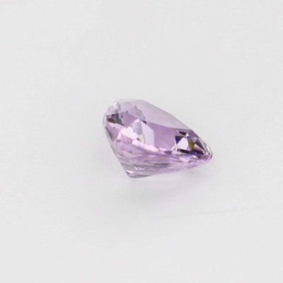 Close-up of a 0.58 carat natural, untreated violet sapphire with excellent clarity and precision cut sparkle
