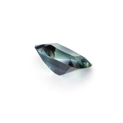 1.30 ct unheated teal sapphire on white background showing blue-green hue and transparency