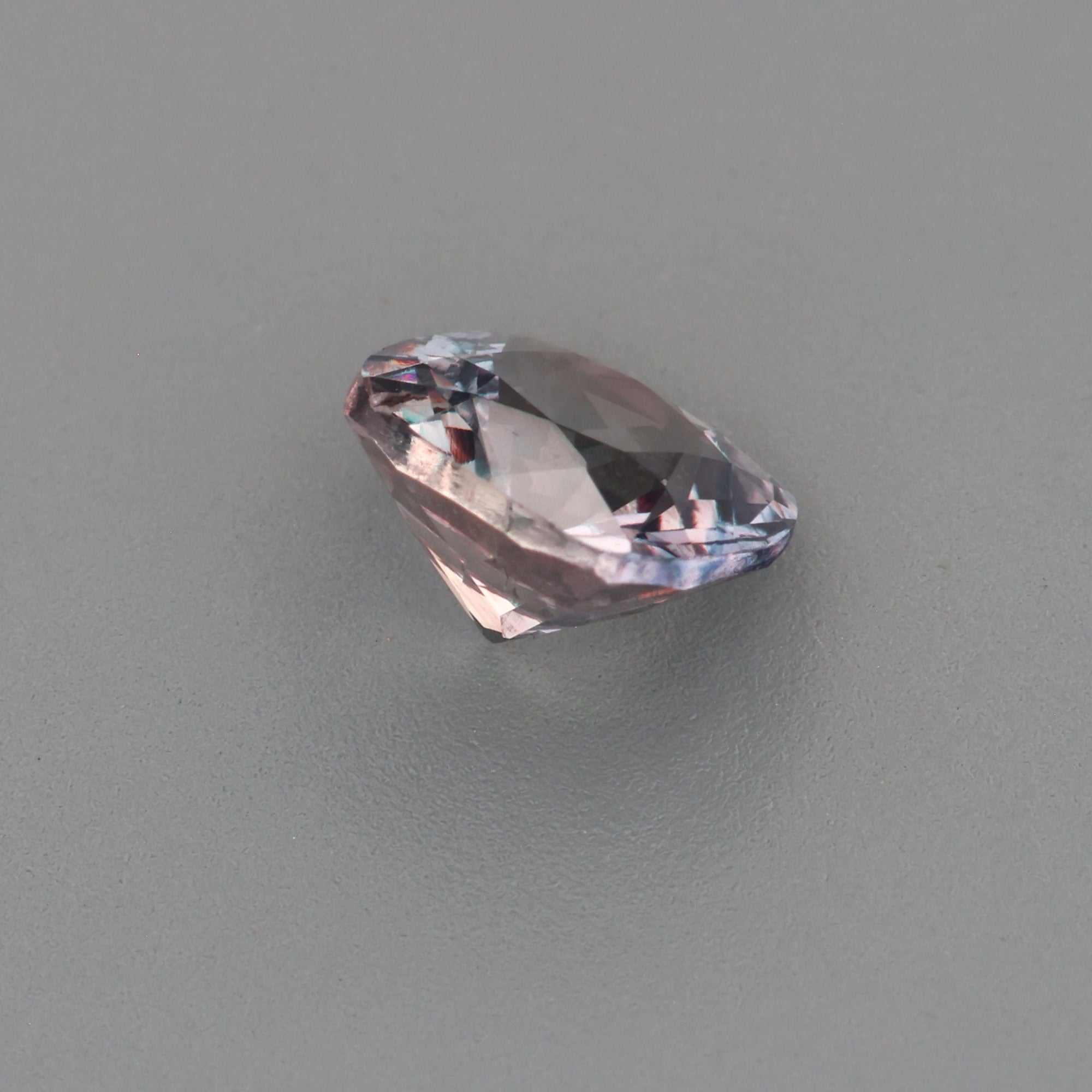 0.63 ct untreated violet sapphire with gray undertones and precision cut sparkle