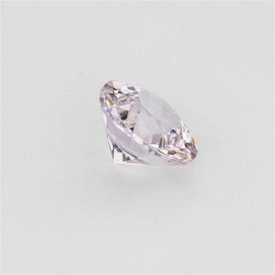 1.30 ct Round White Sapphire Gemstone peach-warm brilliance from one angle