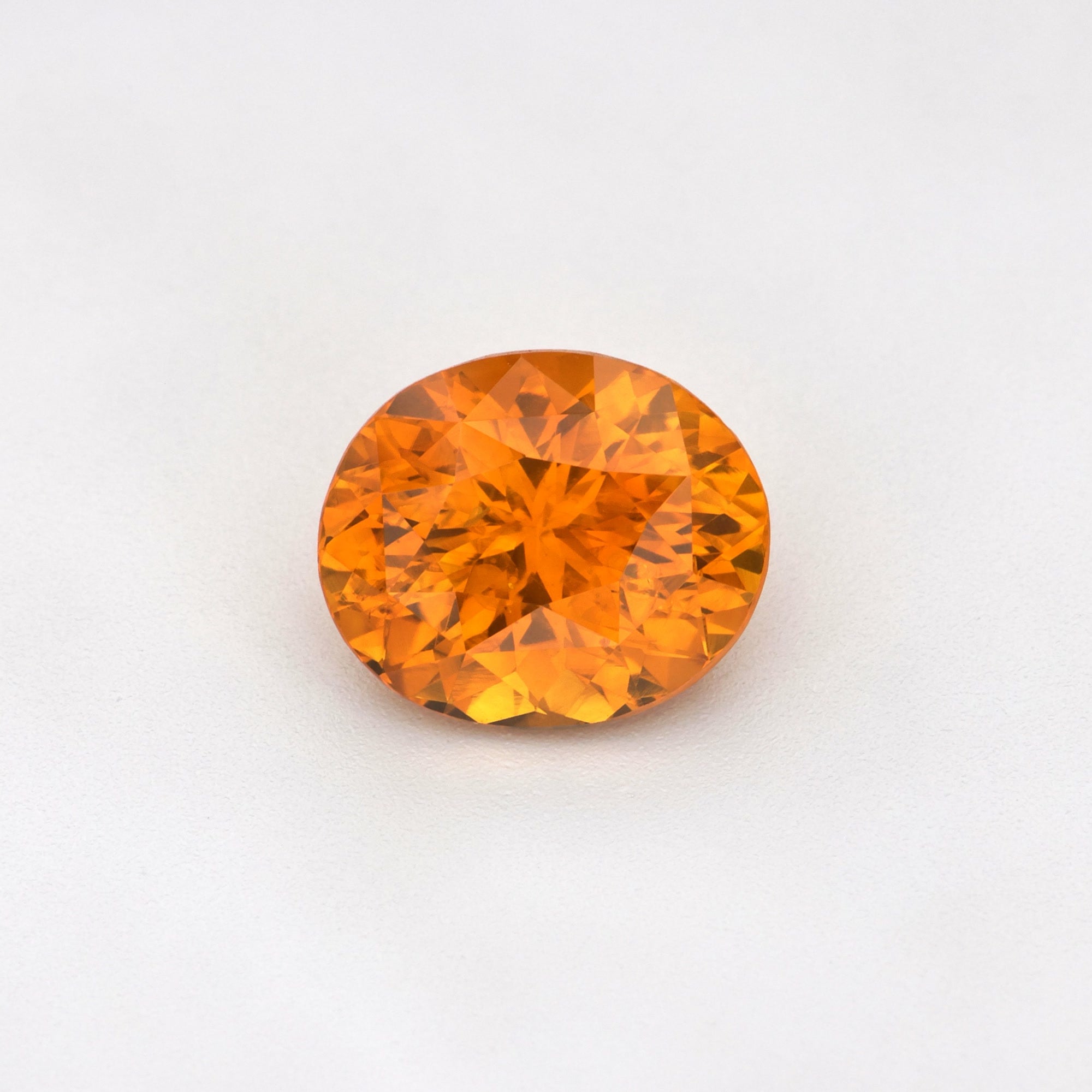 1.63 ct heat-treated Ceylon Orange Sapphire, Oval Cut, showcasing its vivid yellowish-orange hue.