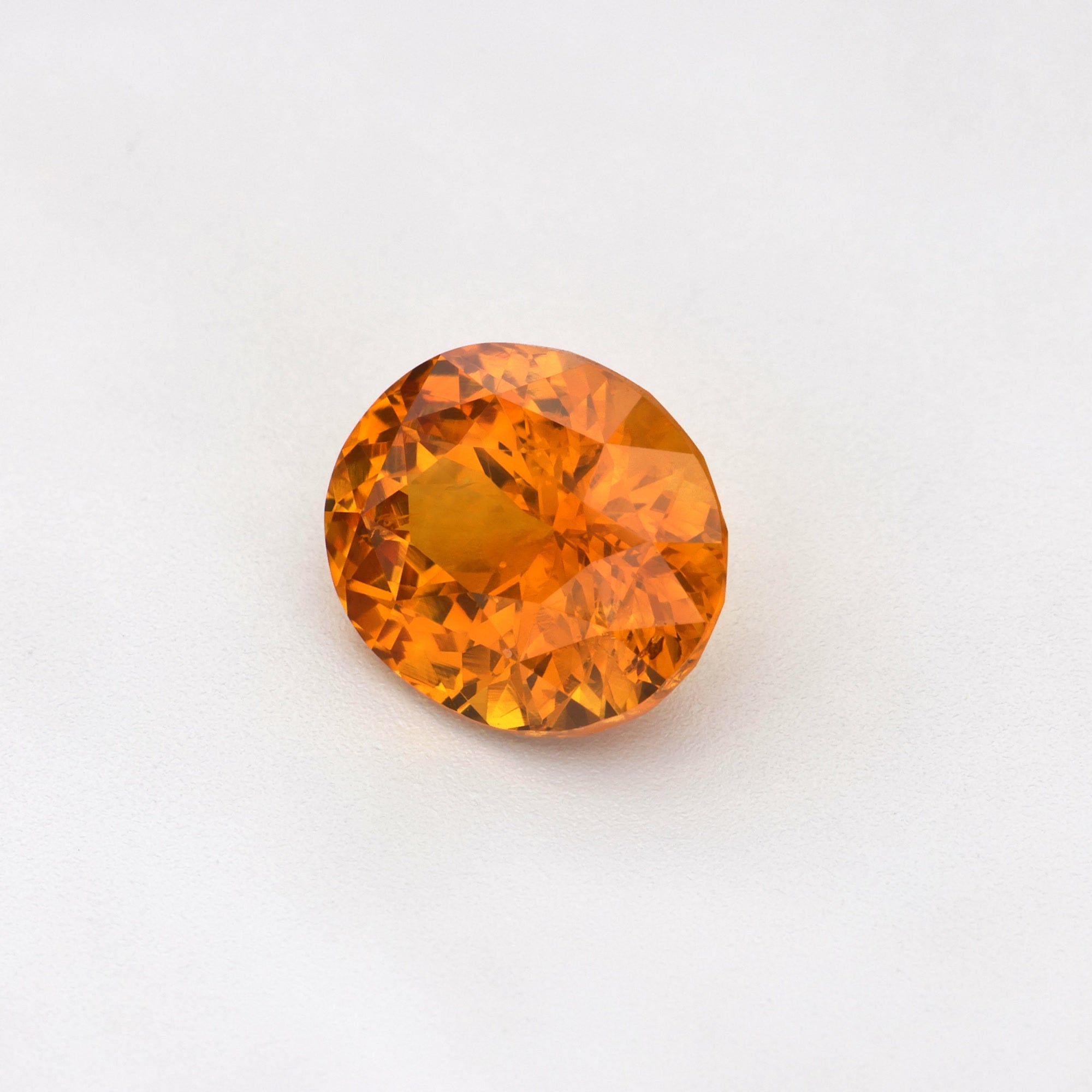 A beautiful 1.63 ct heat-treated Ceylon Orange Sapphire, Oval Cut, displaying its vibrant orange hues.
