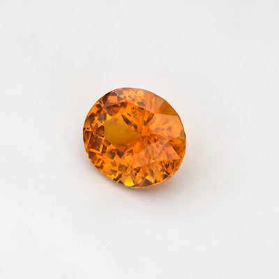 A beautiful 1.63 ct heat-treated Ceylon Orange Sapphire, Oval Cut, displaying its vibrant orange hues.