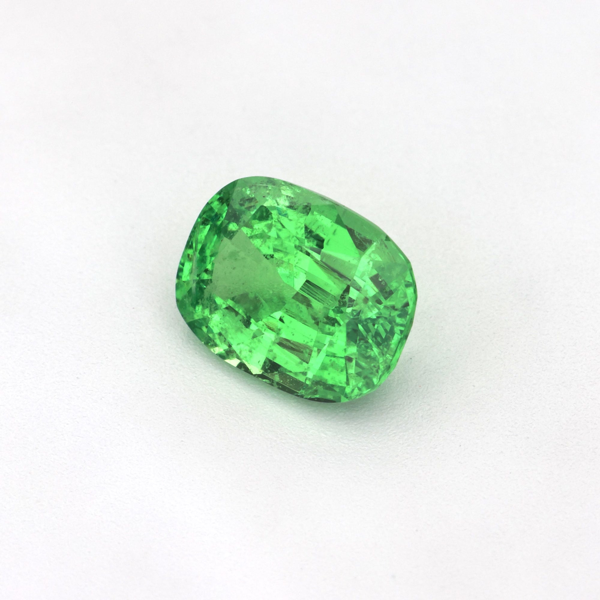 1.06 ct Cushion Tsavorite Garnet, untreated, showing brilliant green color and cushion cut.