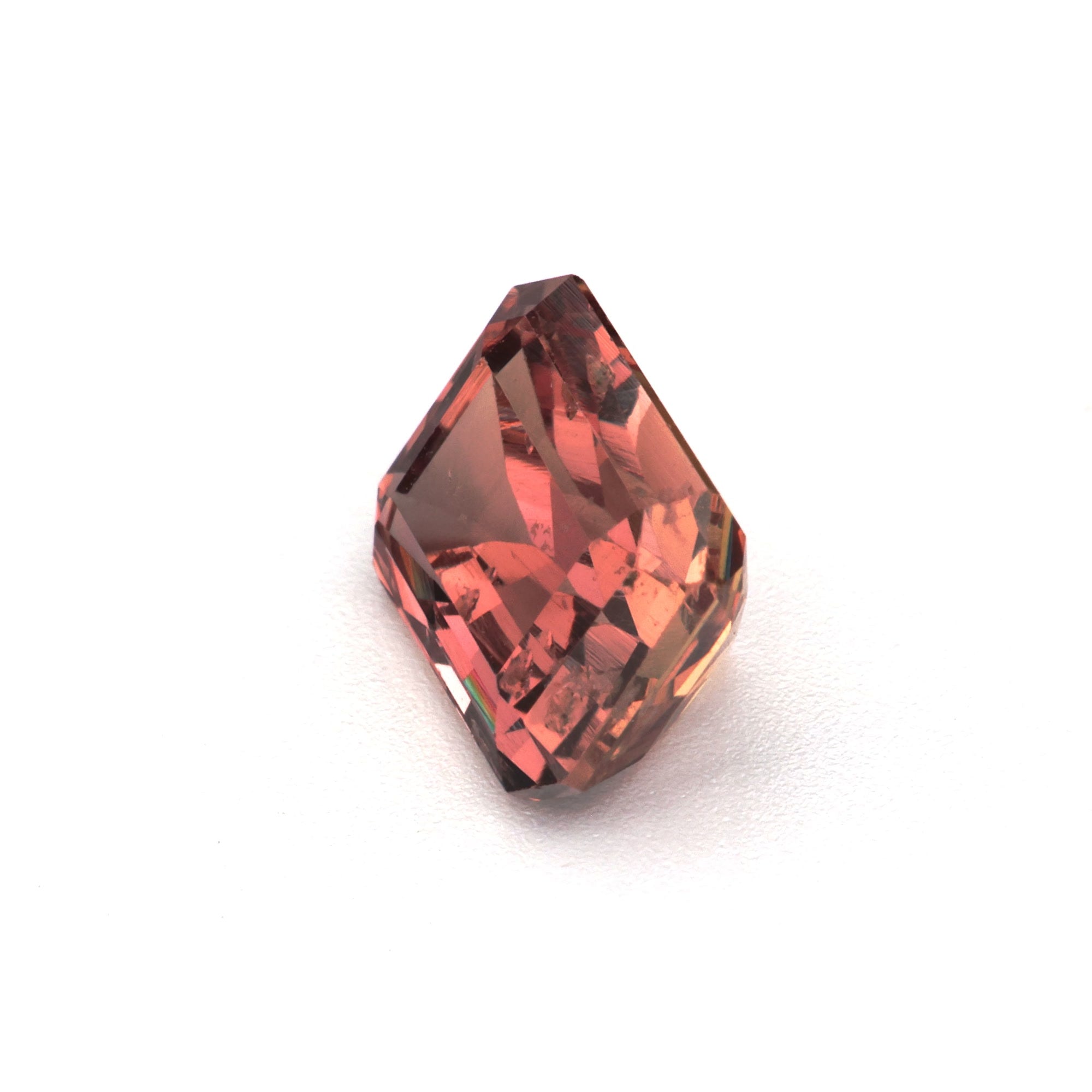 1.62 ct Emerald-Cut Brown Sapphire showcasing warm earthy hues from Madagascar with unique cut and facets.