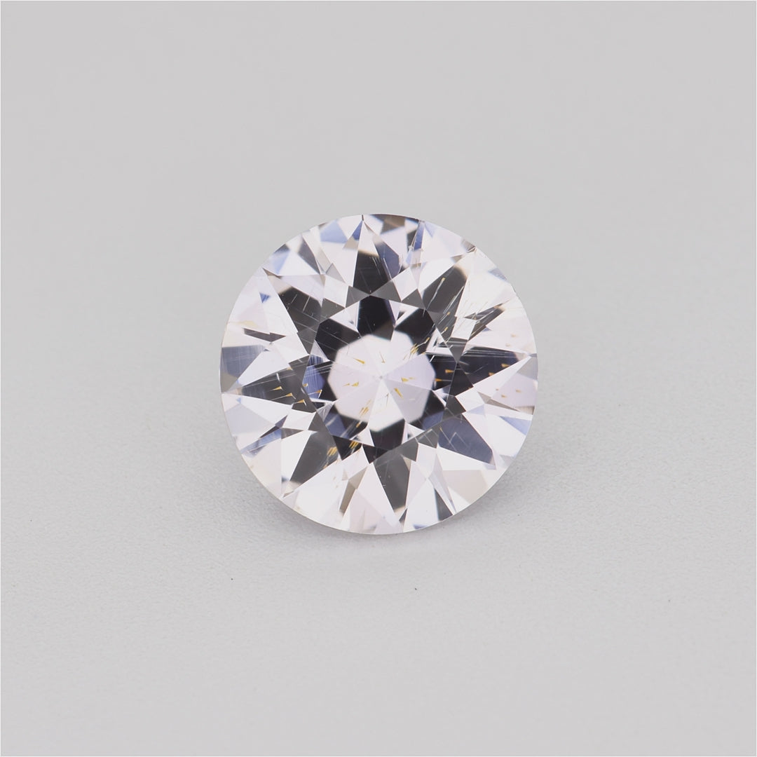 Load video: 1.30 ct round white sapphire video showing diamond-like sparkle and warm tint