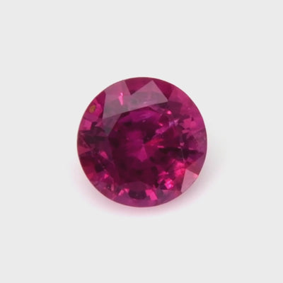 0.52 ct round natural ruby video showing vivid red color and mixed brilliant cut under light