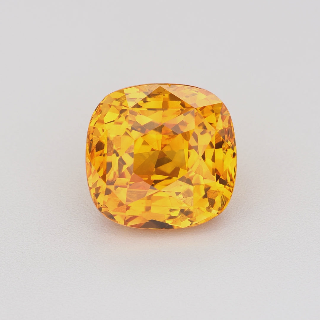2.19 ct square cushion orange sapphire rotating to show golden-orange color and brilliance