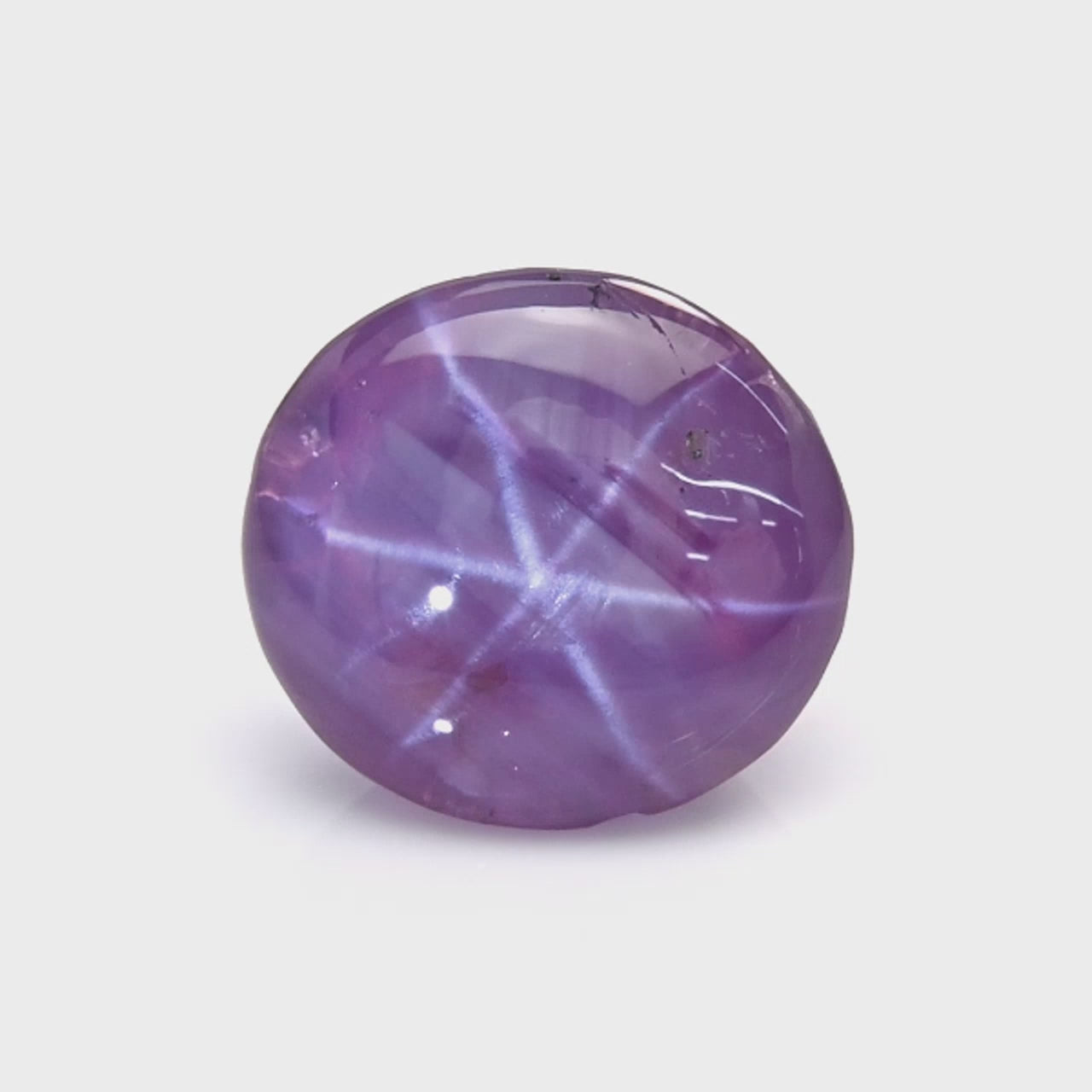 3.26 ct pink star sapphire showing six-ray asterism under direct light