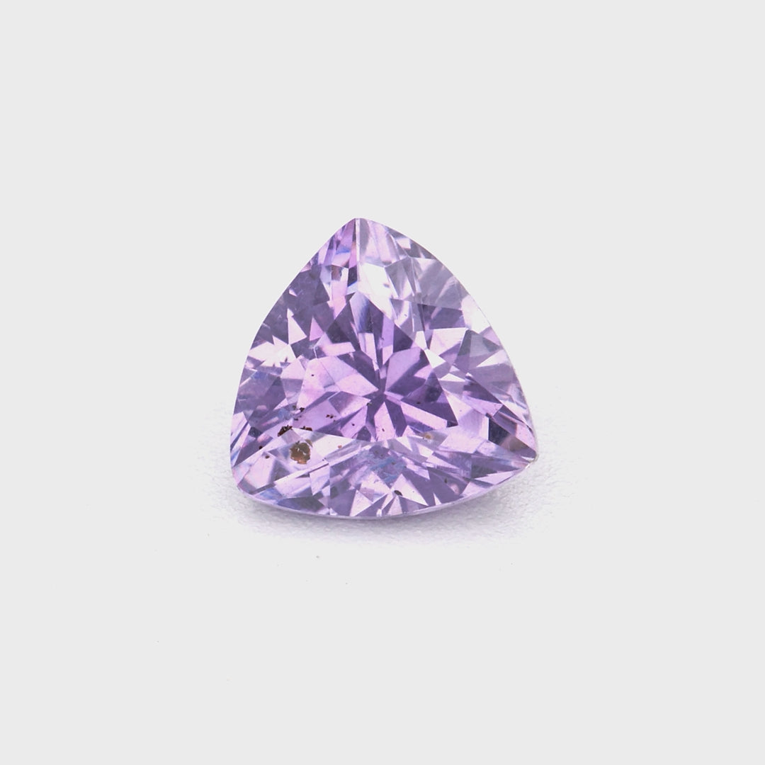 0.42 ct trillion violet sapphire from Ceylon — violet color and cut demonstrated under light