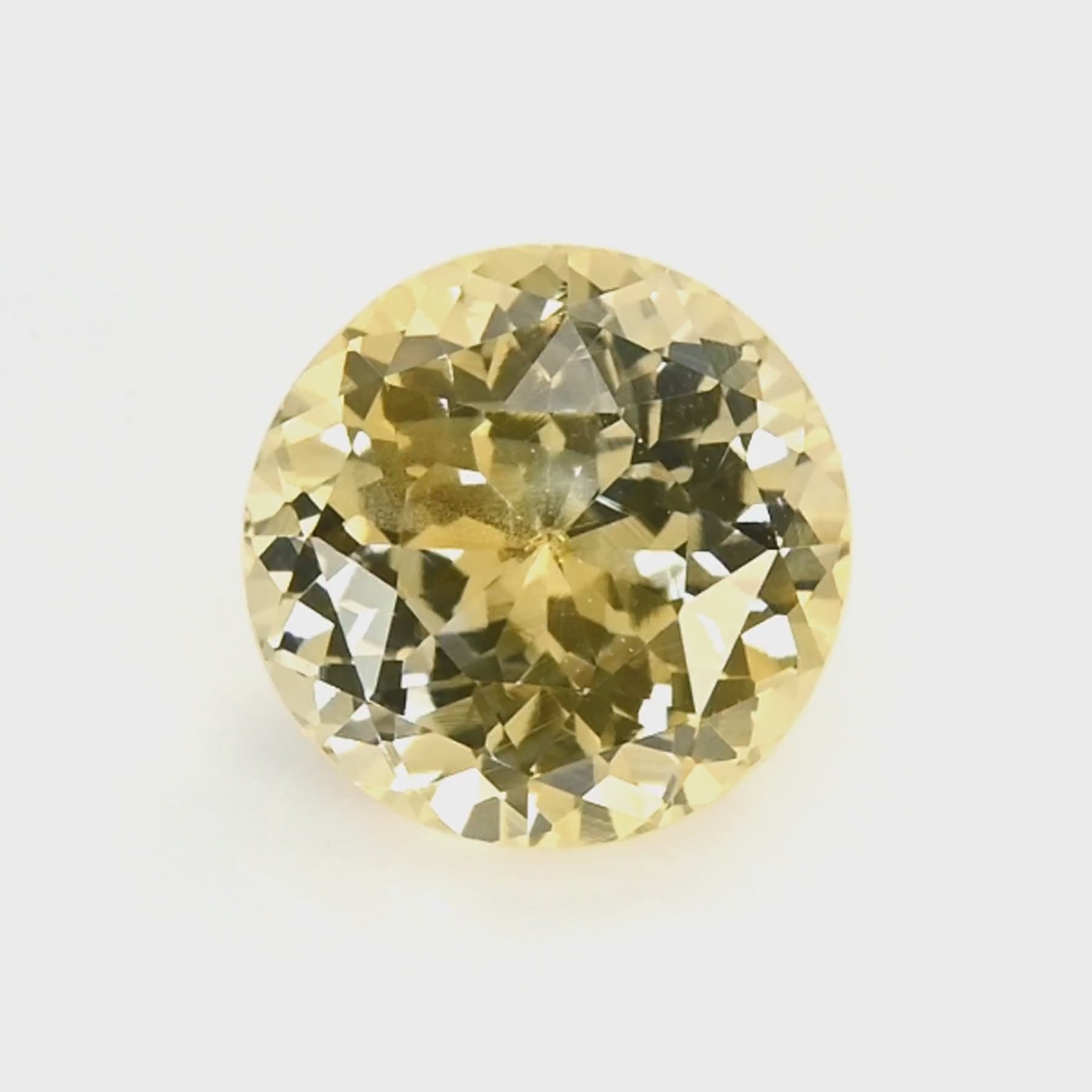 1.21 ct round unheated yellow sapphire rotating to show golden hue and brilliance