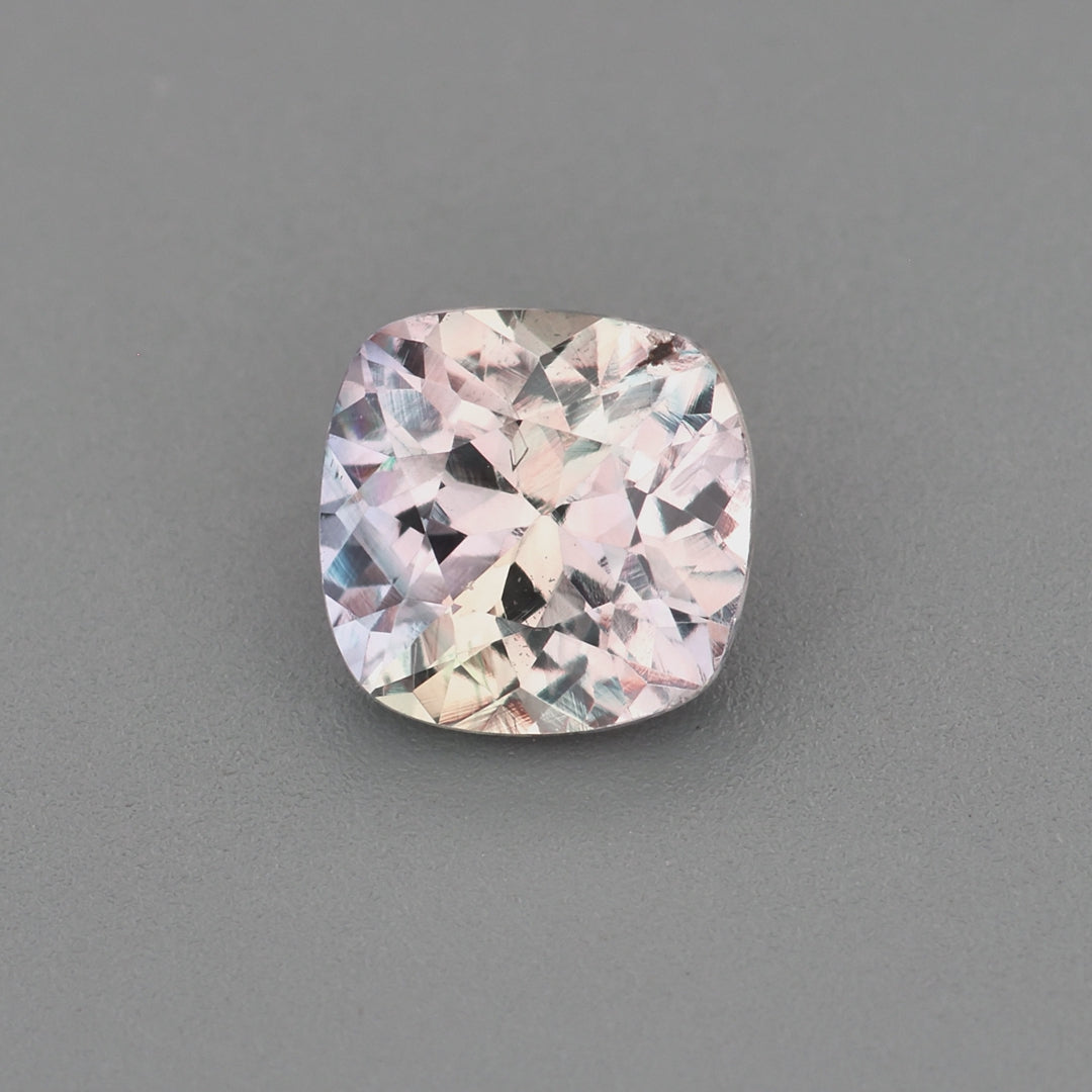Load video: 0.63 ct square cushion unheated violetish-gray sapphire rotating to show color and brilliance