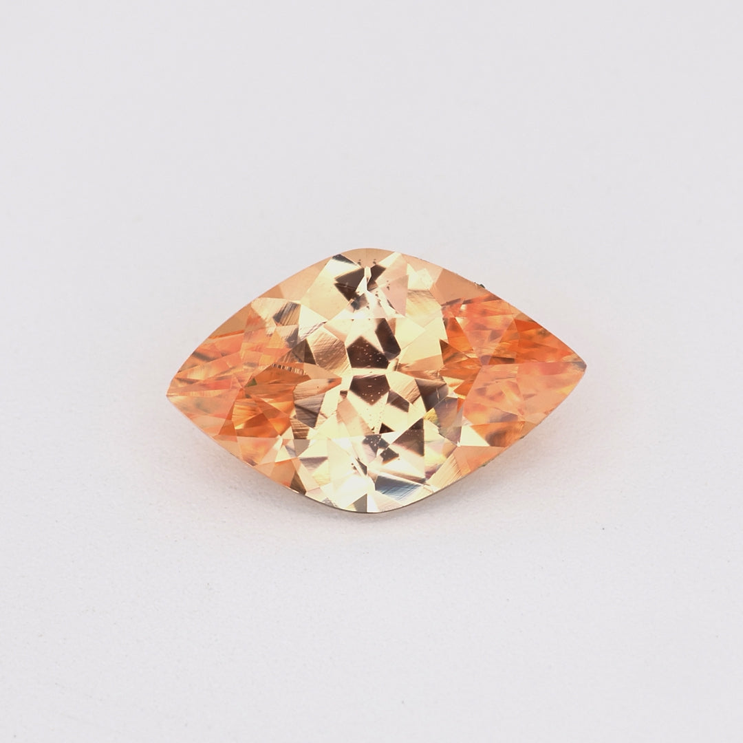 0.79 ct marquise cut unheated peach sapphire rotating to show warm peach color and brilliance
